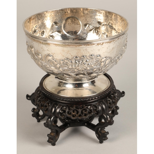 191 - Chinese embossed silver bowl, embossed with flowering prunus, raised on a circular base, maker Hung ... 