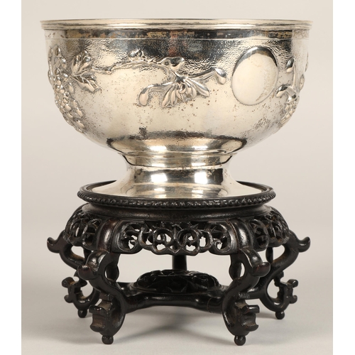 191 - Chinese embossed silver bowl, embossed with flowering prunus, raised on a circular base, maker Hung ... 