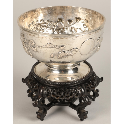 191 - Chinese embossed silver bowl, embossed with flowering prunus, raised on a circular base, maker Hung ... 