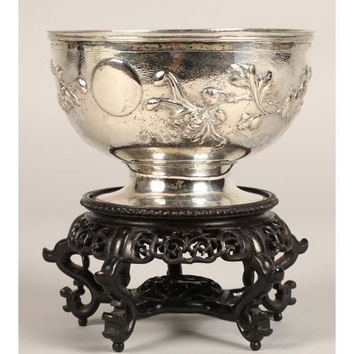 191 - Chinese embossed silver bowl, embossed with flowering prunus, raised on a circular base, maker Hung ... 