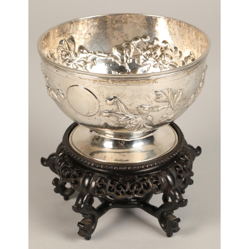 191 - Chinese embossed silver bowl, embossed with flowering prunus, raised on a circular base, maker Hung ... 