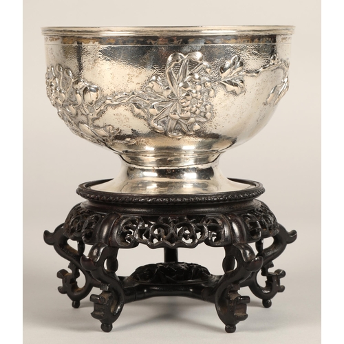 191 - Chinese embossed silver bowl, embossed with flowering prunus, raised on a circular base, maker Hung ... 