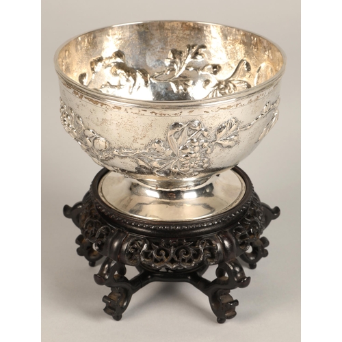 191 - Chinese embossed silver bowl, embossed with flowering prunus, raised on a circular base, maker Hung ... 