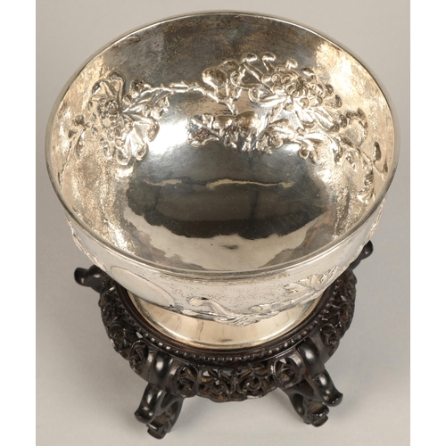 191 - Chinese embossed silver bowl, embossed with flowering prunus, raised on a circular base, maker Hung ... 