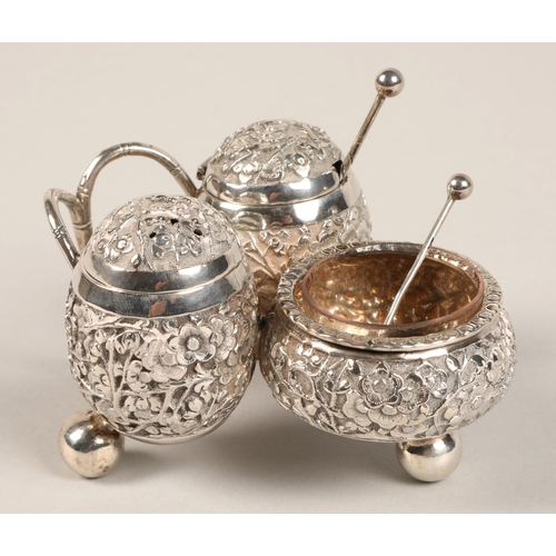 193 - Chinese silver condiment set, with embossed prunus decoration, maker Wan Hin, 134 grams.