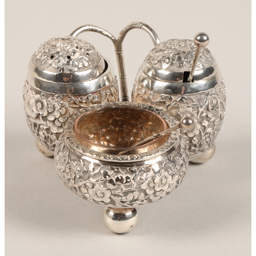 193 - Chinese silver condiment set, with embossed prunus decoration, maker Wan Hin, 134 grams.