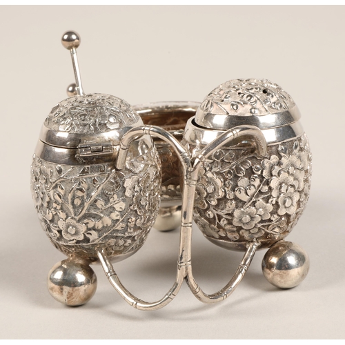 193 - Chinese silver condiment set, with embossed prunus decoration, maker Wan Hin, 134 grams.