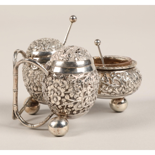 193 - Chinese silver condiment set, with embossed prunus decoration, maker Wan Hin, 134 grams.