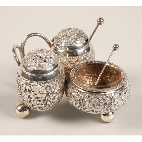 193 - Chinese silver condiment set, with embossed prunus decoration, maker Wan Hin, 134 grams.