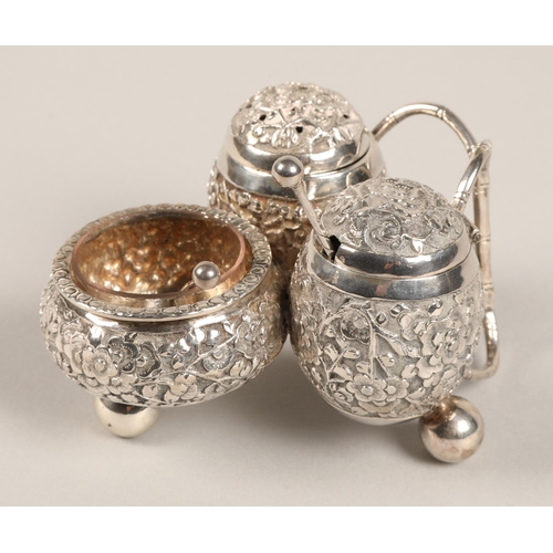 193 - Chinese silver condiment set, with embossed prunus decoration, maker Wan Hin, 134 grams.