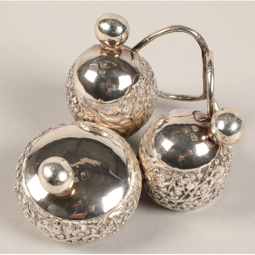 193 - Chinese silver condiment set, with embossed prunus decoration, maker Wan Hin, 134 grams.