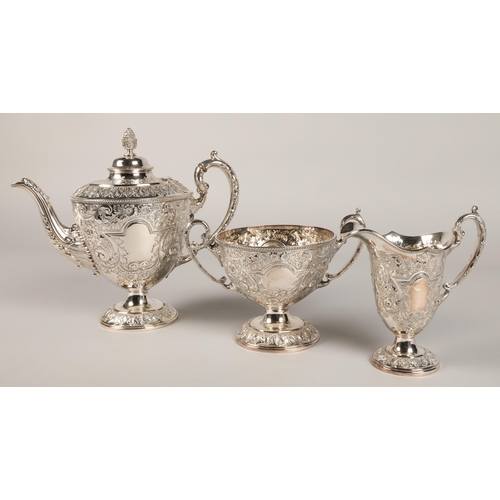 187 - Three piece silver plated tea service with embossed decoration.