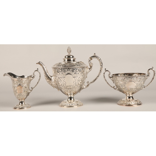 187 - Three piece silver plated tea service with embossed decoration.