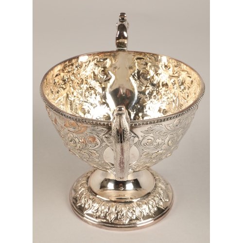 187 - Three piece silver plated tea service with embossed decoration.