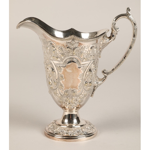 187 - Three piece silver plated tea service with embossed decoration.