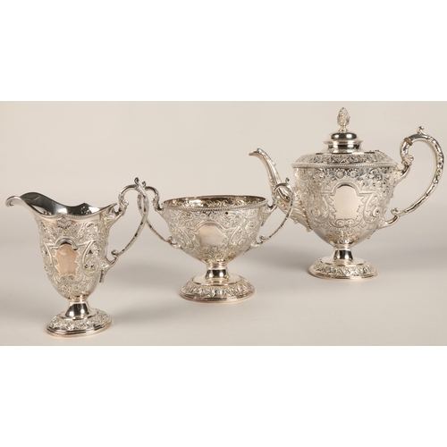 187 - Three piece silver plated tea service with embossed decoration.