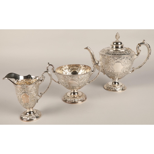 187 - Three piece silver plated tea service with embossed decoration.