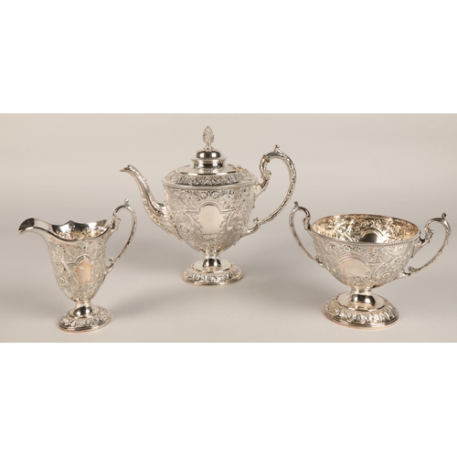 187 - Three piece silver plated tea service with embossed decoration.