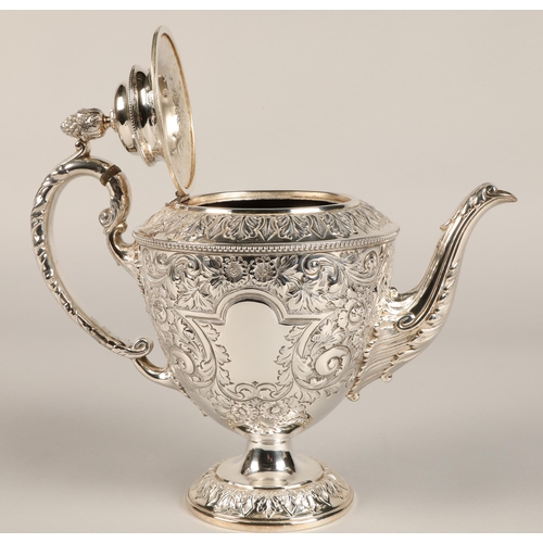 187 - Three piece silver plated tea service with embossed decoration.