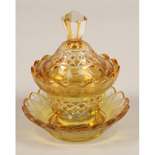 239 - Bohemian amber glass preserve jar, cover and saucer, 22cm high.