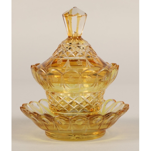 239 - Bohemian amber glass preserve jar, cover and saucer, 22cm high.