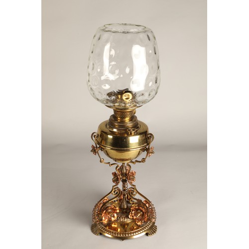 251 - Oil lamp with copper and brass foliate decoration on the base, 62 cm high including glass shade