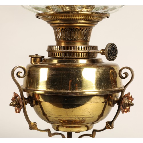 251 - Oil lamp with copper and brass foliate decoration on the base, 62 cm high including glass shade