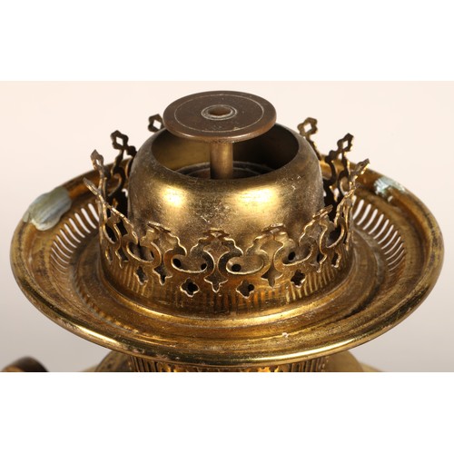 251 - Oil lamp with copper and brass foliate decoration on the base, 62 cm high including glass shade