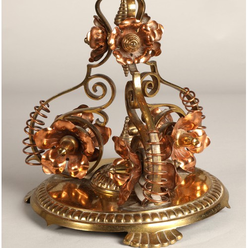 251 - Oil lamp with copper and brass foliate decoration on the base, 62 cm high including glass shade