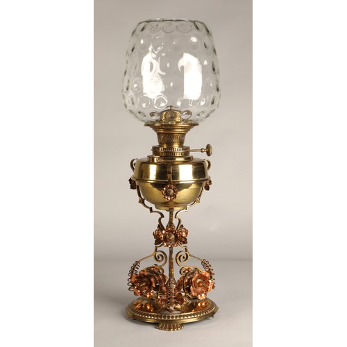 251 - Oil lamp with copper and brass foliate decoration on the base, 62 cm high including glass shade