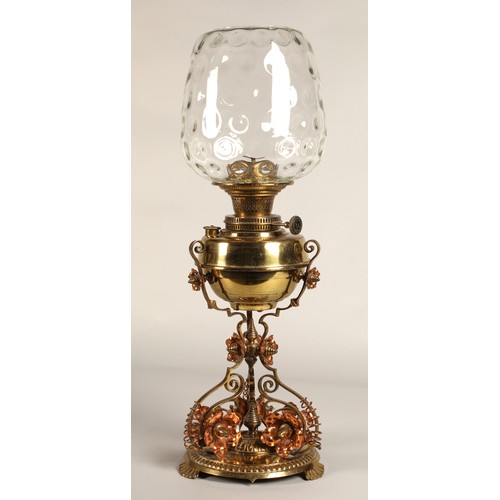 251 - Oil lamp with copper and brass foliate decoration on the base, 62 cm high including glass shade