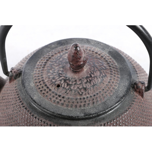 128 - Japanese patinated metal teapot, 17cm high to top of loop handle.