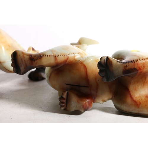 129 - Pair of carved soapstone Fu dogs, 27cm.