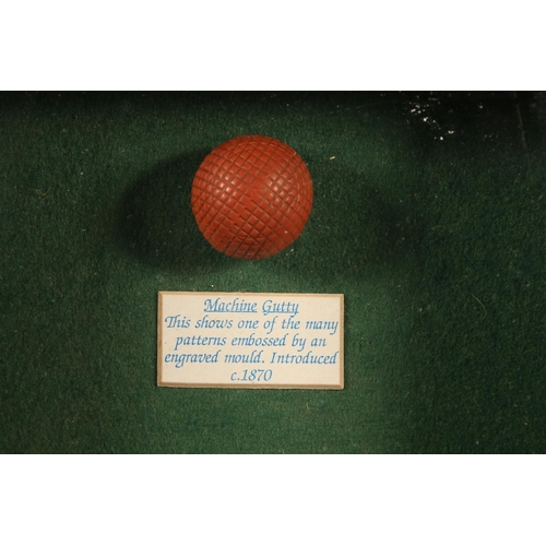 158 - Modern display of a machine gutty golf ball, a jigger head and an old Vanity Fair card of a golfer