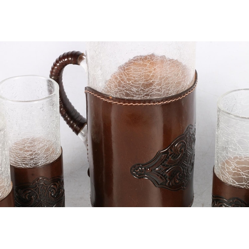 16 - Crackle glass lemonade set in leather holders.