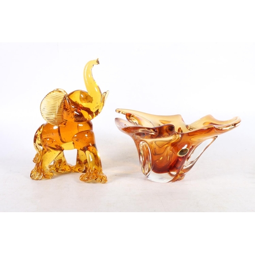 52 - Glassware to include and amber glass free-form bowl, a Dartington Crystal bowl, amber glass elephant... 