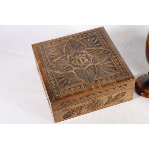 96 - Early 20th century treen table box carved with Gothic style ornamental decoration, a roll-top cigare... 