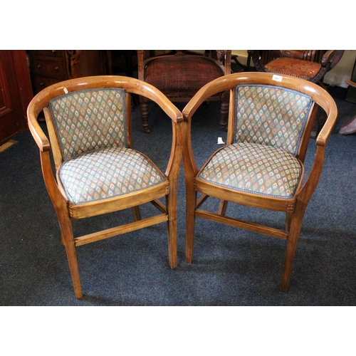 665 - Pair of 20th century mahogany tub armchairs raised on square supports.