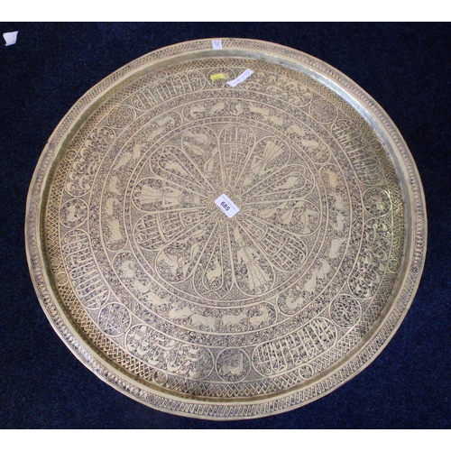 685 - Indian Benares brass charger top table on folding stand, 64cm diameter.