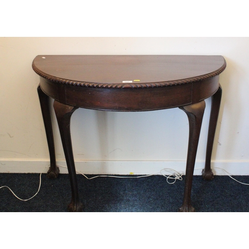 688 - Mahogany demi-line hall table with gadrooned edge raised on cabriole supports terminating in ball an... 