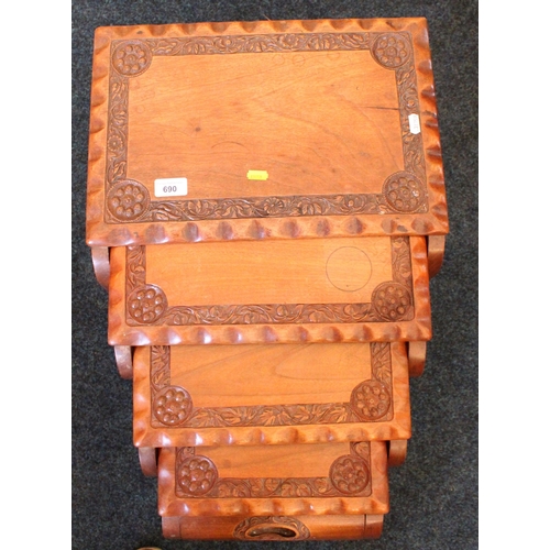 690 - Indian hardwood nest of four tea tables with carved designs of flowers, 43cm wide.