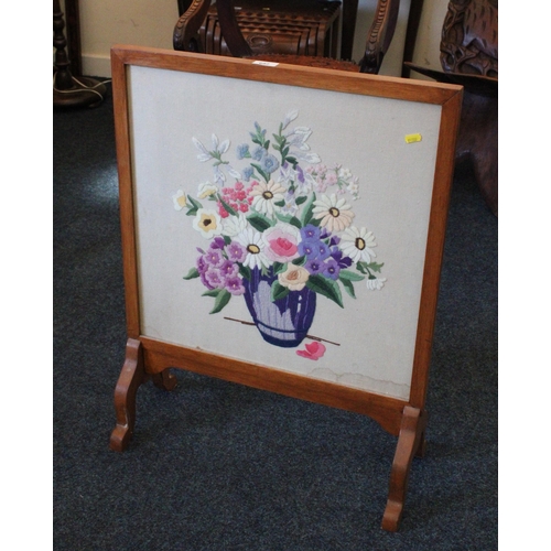 692 - Mahogany framed firescreen with inset needlework panel, 75cm high.