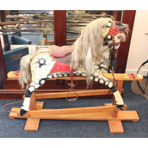 696 - Mid-century dapple-grey rocking horse on trestle stand, 130cm long.