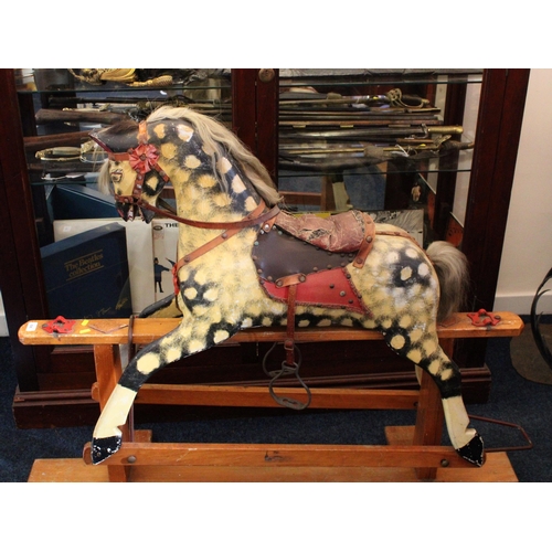 696 - Mid-century dapple-grey rocking horse on trestle stand, 130cm long.