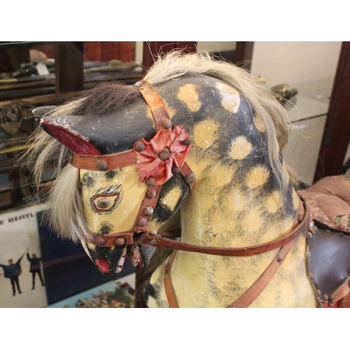 696 - Mid-century dapple-grey rocking horse on trestle stand, 130cm long.