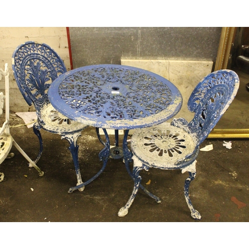 731 - Cast metal garden table and two matching blue painted chairs.