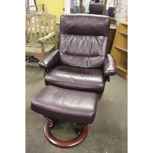 737 - Ekornes Stressless swivel armchair and matching footstool upholstered in dark burgundy leather.