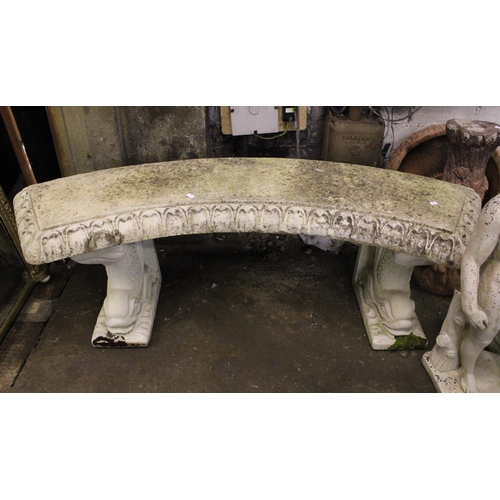 739 - Stoneware garden furniture to include an arch shaped bench raised on dolphin supports, a bird bath, ... 