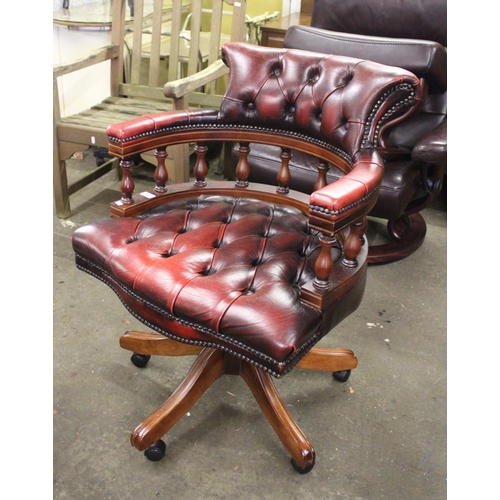 743 - Modern captain's desk chair with button back and seat in burgundy leather.