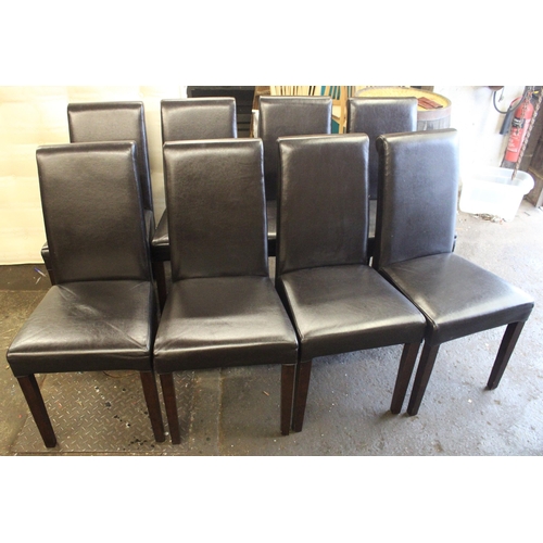 748 - Eight modern black leather scroll back dining chairs.